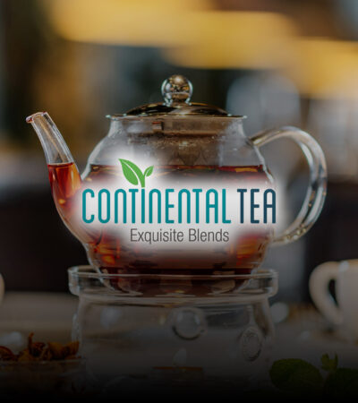 Glass teapot with warmer, with hot herbal tea on table on restau